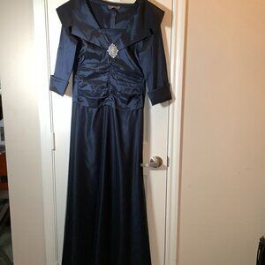 KM Collection by Milla Bell Navy Blue Gown with lace covering and silver brooch